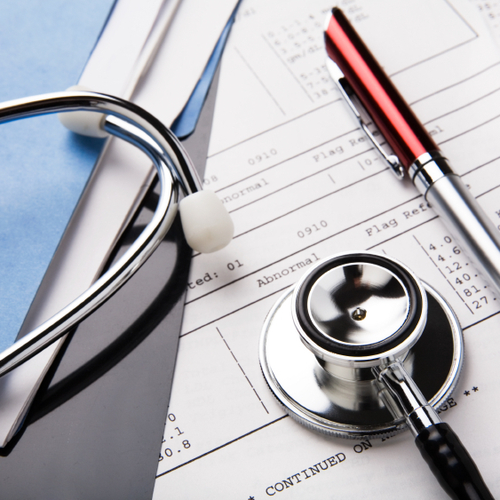 Stethoscope and pen on medical files