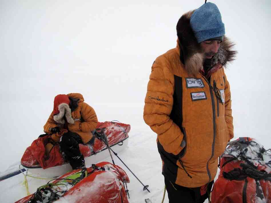 Larsen's team members Antony Jinman (left) and Darcy St. Laurent huddle against the blowing wind. Larsen's team members Antony Jinman (left) and Darcy St. Laurent huddle against the blowing wind.