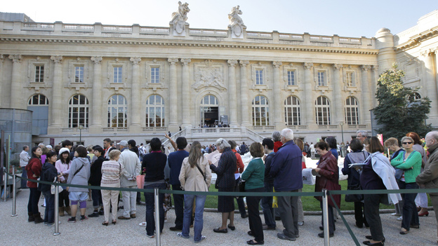 Visitors wait in line outside the Grand Palais museum in Paris.