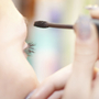 woman puts on mascara