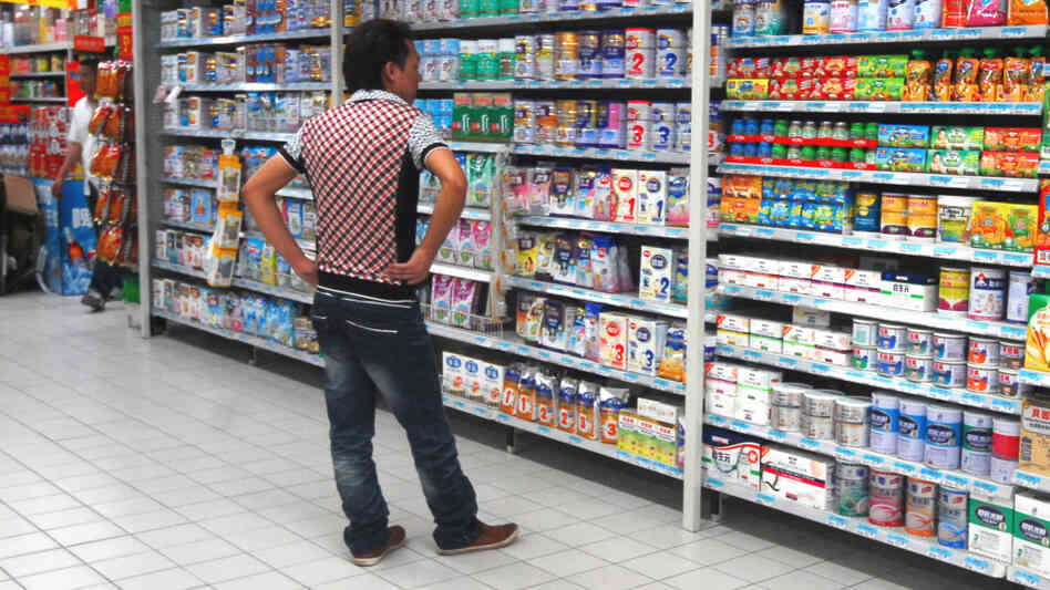 A man shops for milk powder at a supermarket in Guangzhou, south Guangdong Province A man shops for milk powder at a supermarket in Guangzhou, south Guangdong Province