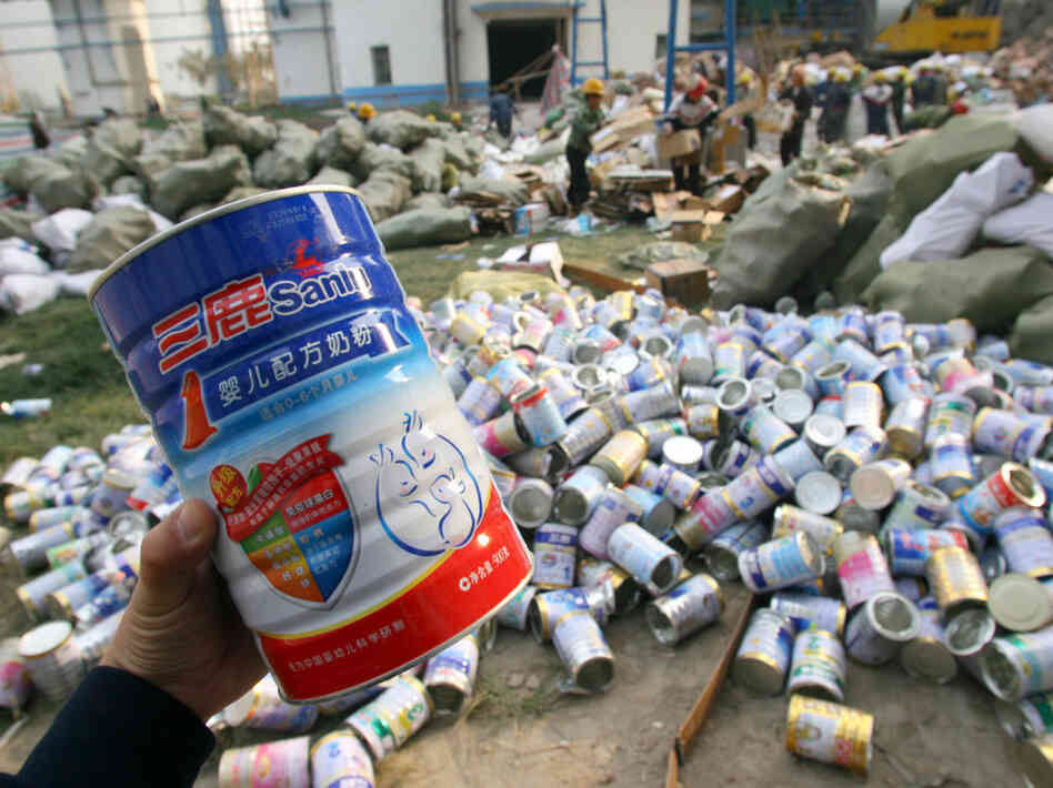 Workers pile up empty tins after contaminated Sanlu milk powder was poured into bags for destruction Workers pile up empty tins after contaminated Sanlu milk powder was poured into bags for destruction