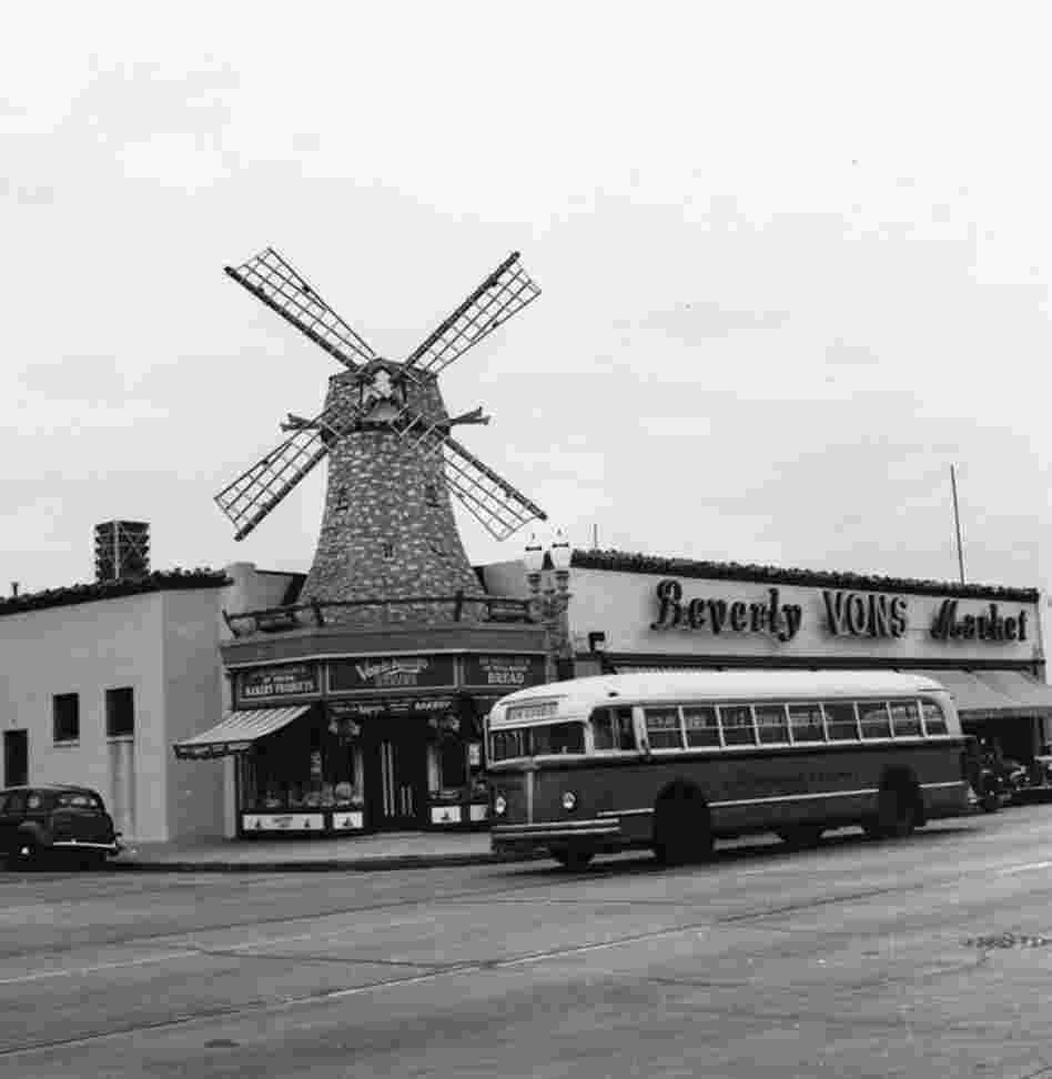 A Los Angeles Railway bus travels past a Van de Kamp's Bakery in Beverly Hills.