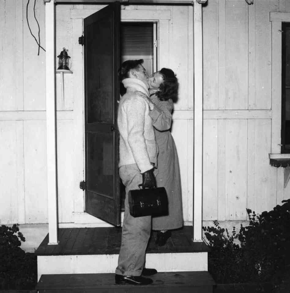 Cole Weston, son of photographer Edward Weston, kisses his wife, Dorothy, goodbye outside their home before heading off to work. At the time, Weston worked as a metalsmith at the Lockheed Aircraft Company plant in Burbank, earning 51 cents an hour.