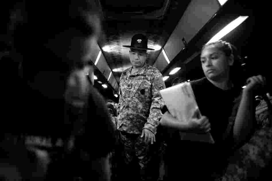 Drill sergeant Nicholas Pieroni gives instructions to arriving recruits before they get off a bus at the U.S. Army Training Center reception facility at Fort Jackson in Columbia, S.C. 