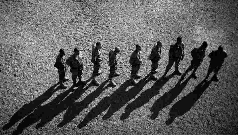 Soldiers stand in line while waiting their turn on one of the tower obstacles at Fort Jackson.