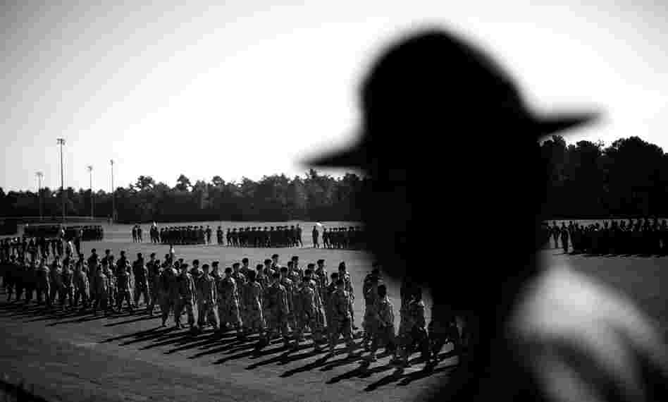 A drill sergeant watches the graduation ceremony for soldiers who completed basic training at Fort Jackson.