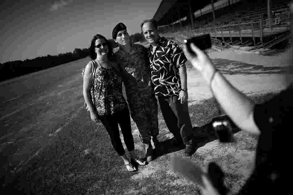 Brian Wynne (center) stands with his parents after the graduation ceremony.