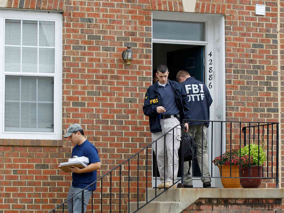 FBI Investigators leave the home of Farooque Ahmed in Ashburn, Va., on Wednesday. FBI Investigators leave the home of Farooque Ahmed in Ashburn, Va., on Wednesday.