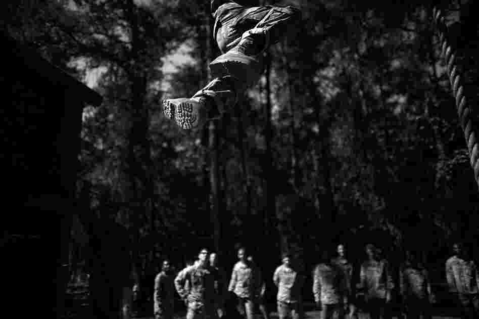 A soldier passes over head while competing a climbing exercise on one of the many traditional obstacle courses. The Army has found that 79 percent of soldiers who commit suicide do so during major transitions in their service. Basic training and the first three years of duty pose some of the toughest transitions for new soldiers.