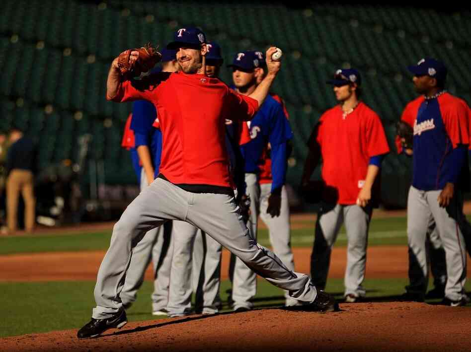 Texas Rangers' ace Cliff Lee throws during a workout session. Texas Rangers' ace Cliff Lee throws during a workout session.