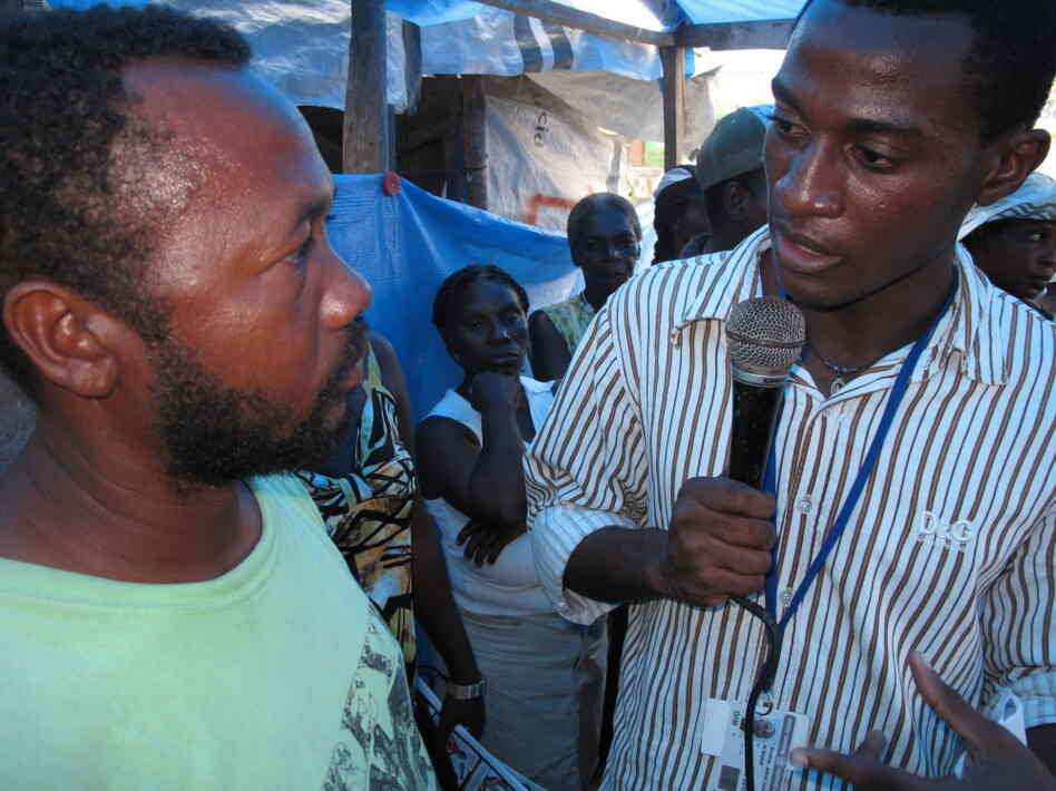 Jethro Sereme records for a radio broadcast at a tent camp in Haiti. Jethro Sereme records for a radio broadcast at a tent camp in Haiti.