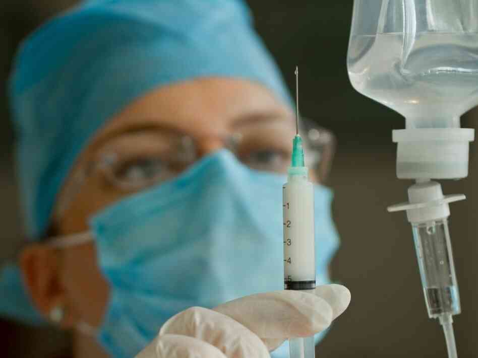 doctor prepares a syringe doctor prepares a syringe
