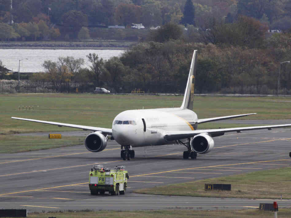 A United Parcel Service jet sat isolated on a runway at Philadelphia International Airport. A United Parcel Service jet sat isolated on a runway at Philadelphia International Airport.