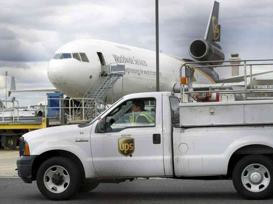 A UPS worker drives past a UPS plane at Liberty Airport in Newark, N.J., on Friday. A UPS worker drives past a UPS plane at Liberty Airport in Newark, N.J., on Friday.