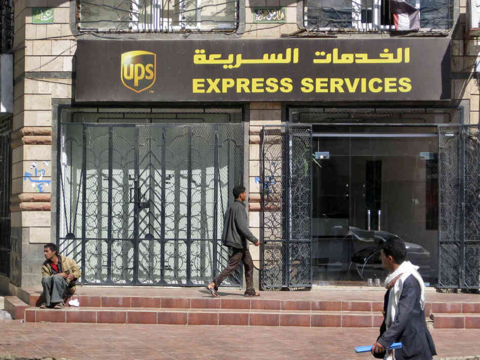 Yemenis walk past the UPS office in the capital San'a on Saturday. Yemenis walk past the UPS office in the capital San'a on Saturday.