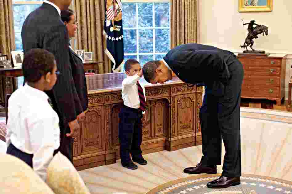 Pete Souza made this photo, which President Obama has said is one of his favorites, when White House staffer Carlton Philadelphia brought his family to meet the President. His son declared that he'd been told that he and the President had the same haircut. Obama bent over so the child could get a better look. 