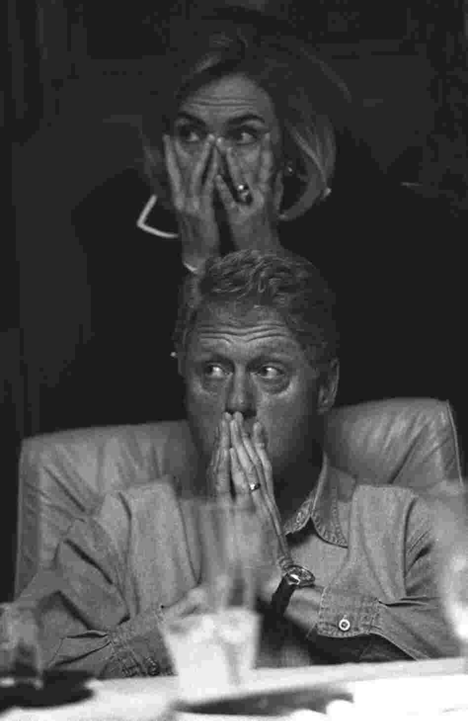 A number of Bob McNeely's images show President Clinton and the First Lady fully engaged on issues together, as in this moment when they are listening to a briefing on board Air Force One. 
