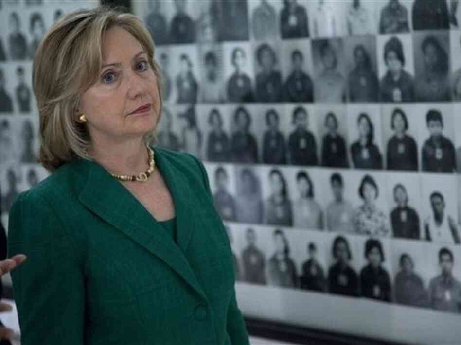 Secretary of State Hillary Clinton looks at a wall of faces of those killed by the Khmer Rouge. Secretary of State Hillary Clinton looks at a wall of faces of those killed by the Khmer Rouge.
