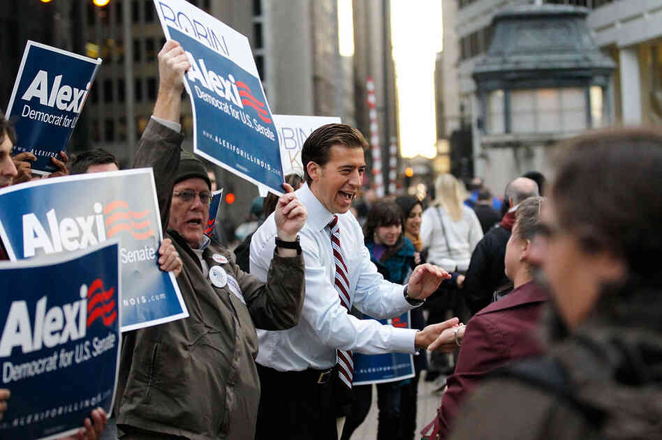 Illinois Democrat Alexi Giannoulias (center) greets commuters after voting in Chicago. Giannoulias lost the race for President Obama's former Senate seat to Republican Rep. Mark Kirk. 