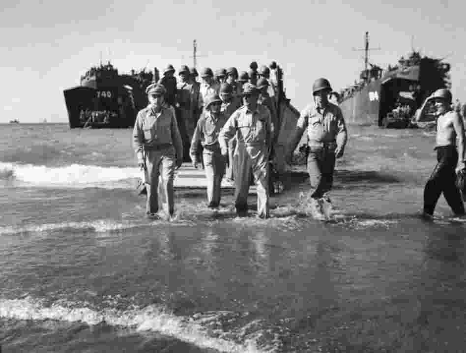 After being driven by the Japanese from the Philippines in the early days of World War II, General MacArthur (center) famously vowed to return. Almost three years later, in 1945, a photography-aware MacArthur made sure that Carl Mydans was there as he splashed ashore. 