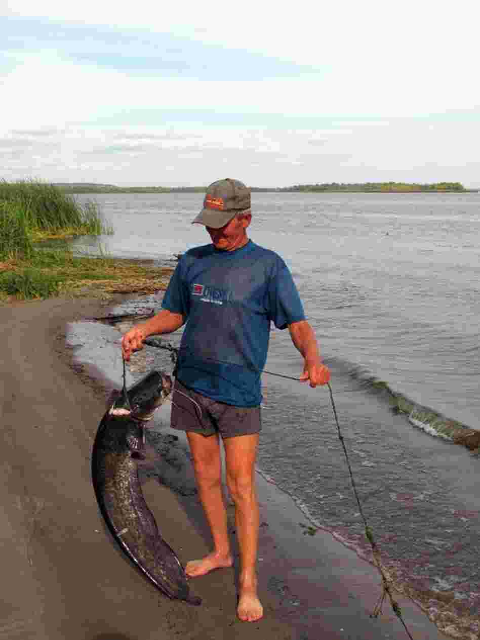 Anatolievich shows off a prize carp at his fishing camp in Usovka on the Volga.