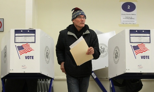 A voter walks away from a booth after marking his ballot at a Manhattan polling place.