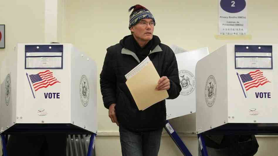 A voter walks away from a booth after marking his ballot at a Manhattan polling place.