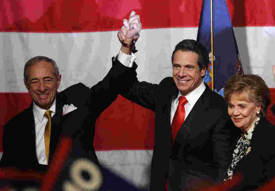 Although a Democrat, New York Governor-elect Andrew Cuomo (center) pledged to cap property-tax rates, appealing to Republican voters. 