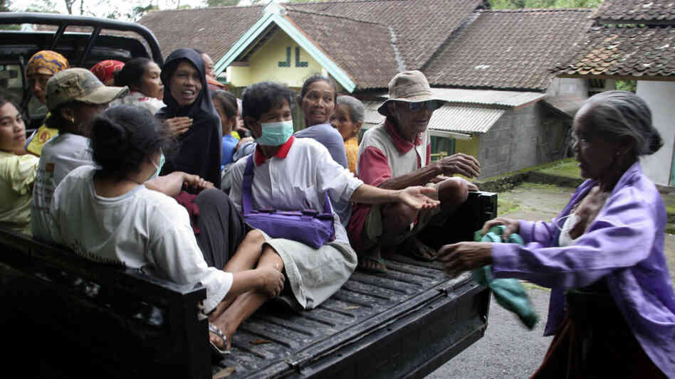 villagers board a truck as they evacuate villagers board a truck as they evacuate