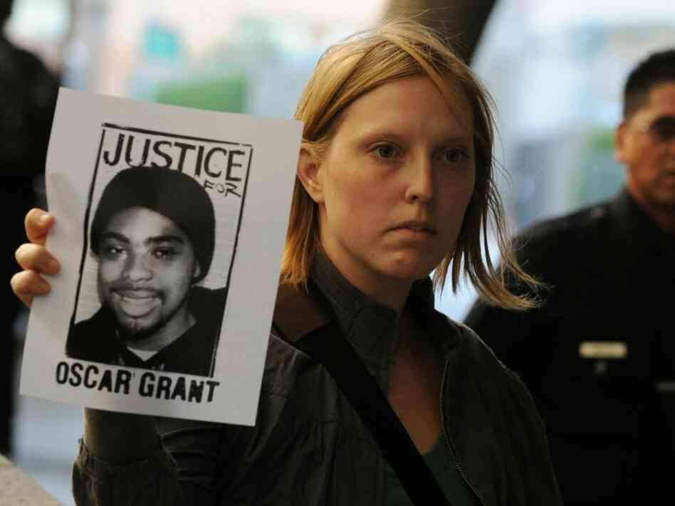A protester with a portrait of slain tra A protester with a portrait of slain tra