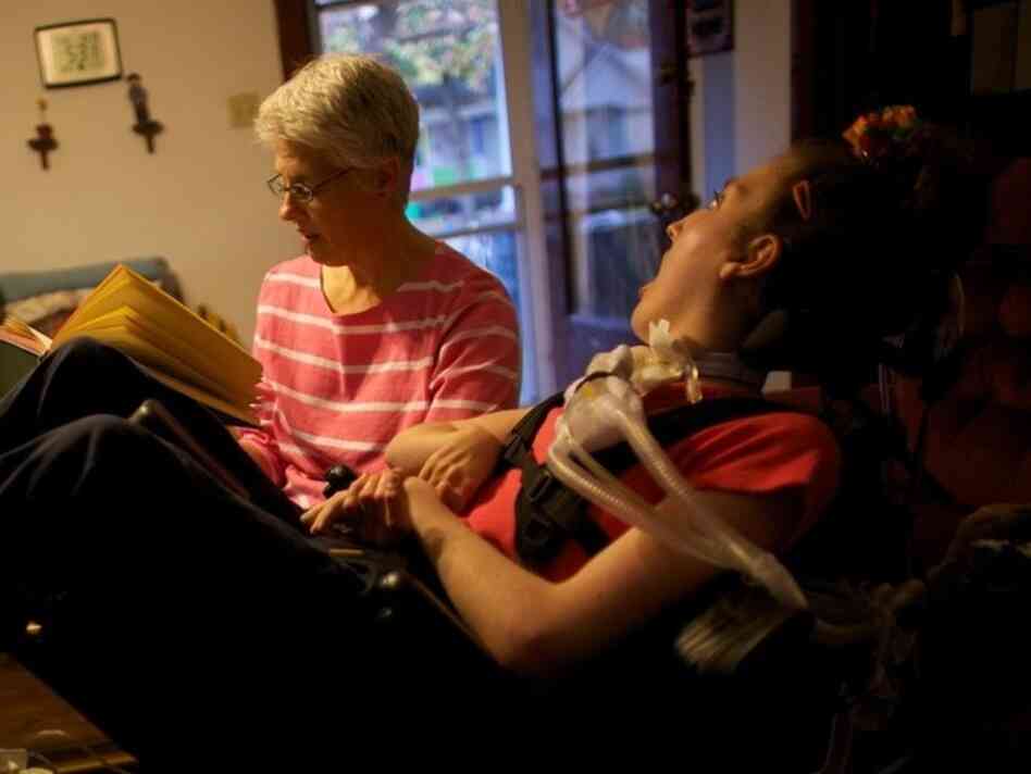 Olivia Welter's mom, Tamara, reads to her in the family's living room in Lincoln, Ill. Olivia Welter's mom, Tamara, reads to her in the family's living room in Lincoln, Ill.