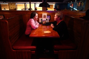 Beckett (left) and her mom Julie go to a restaurant in Cedar Rapids, Iowa, once a week to catch up. Beckett is now famous among children's advocates and travels the country with her mom working for laws and programs in favor of homecare.