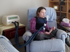 Katie Beckett fits herself with a vibrating vest that helps clear mucous from her lungs. Katie Beckett fits herself with a vibrating vest that helps clear mucous from her lungs.