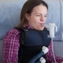 Katie Beckett fits herself with a vibrating vest that helps clear mucous from her lungs. Katie Beckett fits herself with a vibrating vest that helps clear mucous from her lungs.