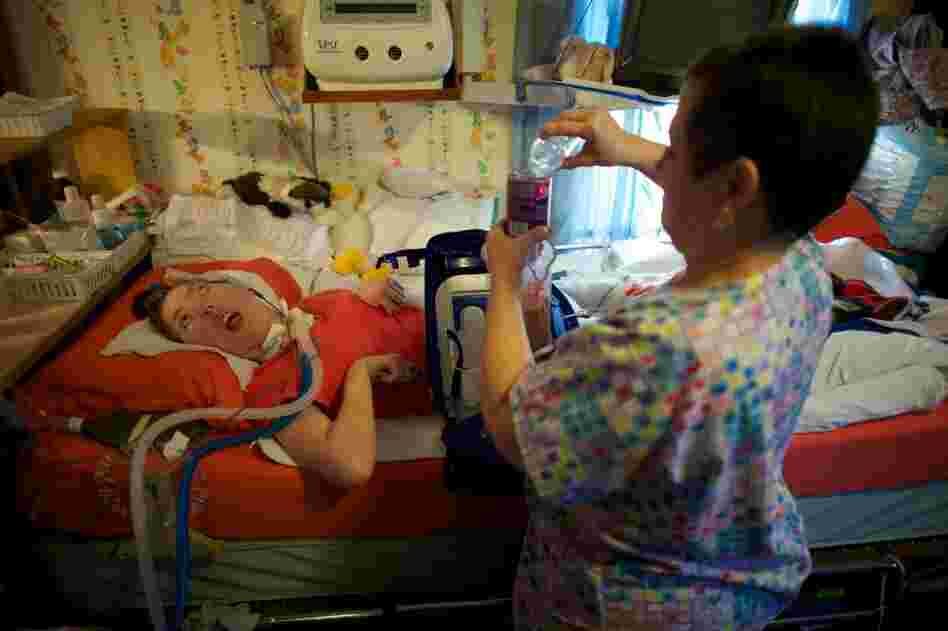 Olivia Welter turns 21 on Nov.9. On her birthday, she will no longer be eligible for the program for disabled children that has kept her healthy. She will lose state funds that cover the expense of nurses like Helen Houchins who prepares liquid food that is sent directly into Welter's stomach through a feeding tube.