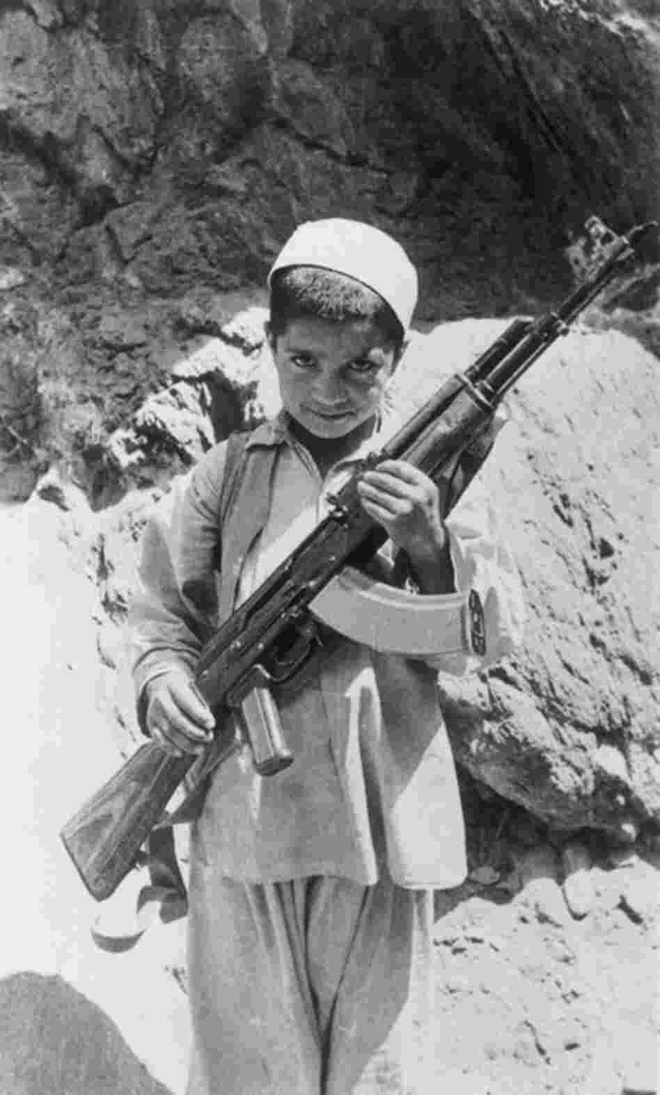 Exactly 100 years later, Russian paratroopers landed in Kabul again, the country already in civil war. Afghanistan's prime minister tried to usher in a more westernized policy, and was met by a strong traditional opposition, and a guerrilla force called Mojahedin, a holy mission for Allah. Here, an Afghan child joins the guerrilla movement, 1980. 