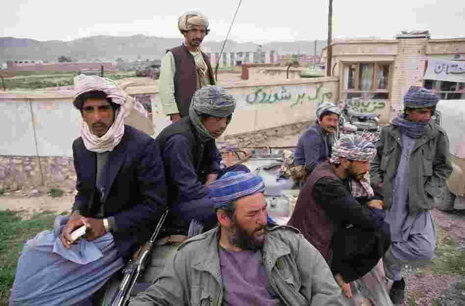 After wresting control of the city of Herat from the Soviet-backed communist regime, Mojahedin fighters, armed with AK-47 automatic assault rifles and wearing typical Afghan turbans, sit on top of a Soviet-made armoured personnel carrier in western Afghanistan, 1992. 