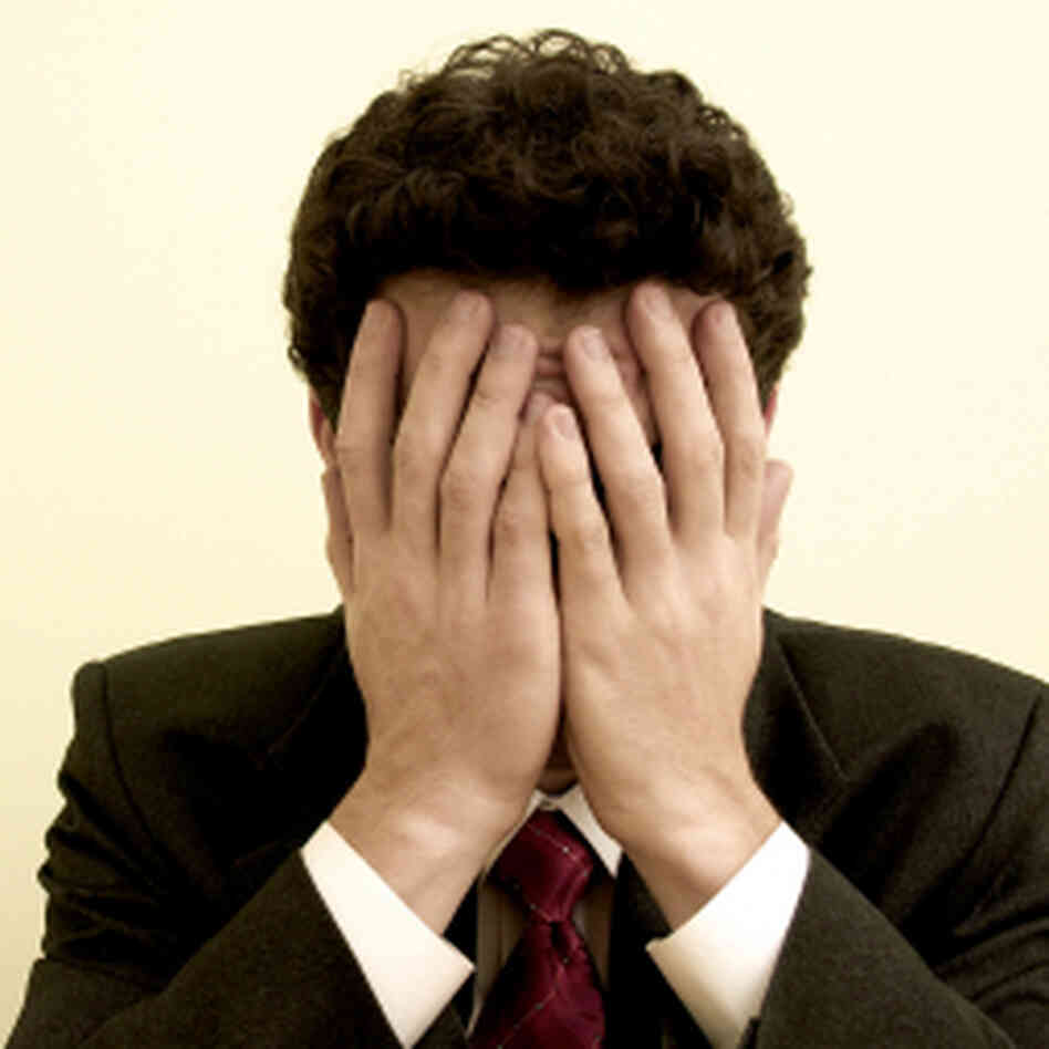 a man with his hands over his eyes a man with his hands over his eyes