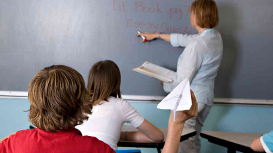 A boy acts up in class. A boy acts up in class.
