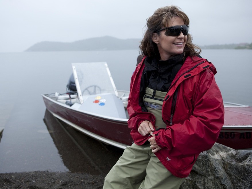 Sarah Palin leans against her husband Todd's boat, ready to head up the river