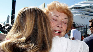 Jeanne Ralston, facing camera, gets a hug from her daughter Cindi Wolfe after disembarking.