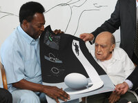 Brazilian football legend Pele and Niemeyer look at the design for the Football Museum of Santos, Nov. 4, 2010, in Rio de Janeiro.