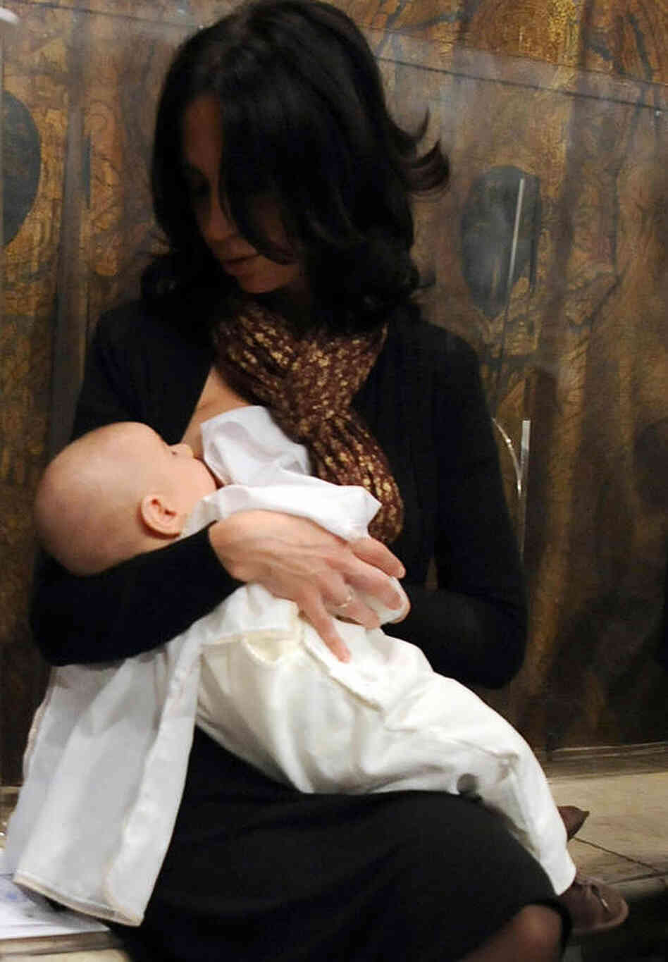 A mother breastfeeds her baby after he w A mother breastfeeds her baby after he w