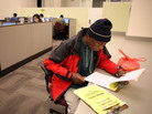 Maurice Jones looks through job listings at a career center in Oakland, Calif. Maurice Jones looks through job listings at a career center in Oakland, Calif.
