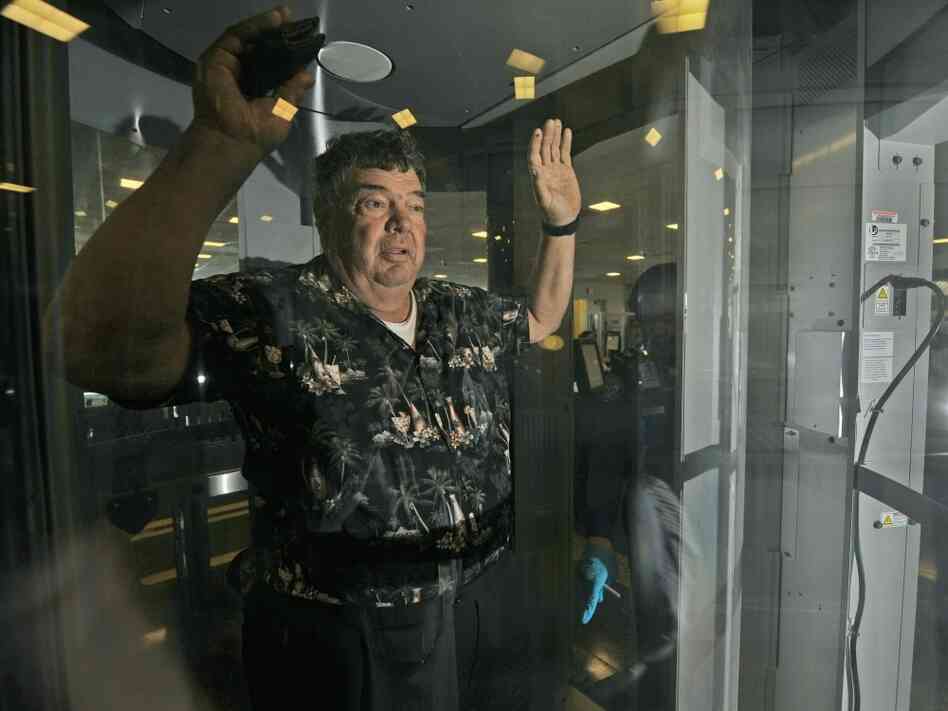 A passenger at Ronald Reagan Washington National Airport is subjected to a full-body scan. A passenger at Ronald Reagan Washington National Airport is subjected to a full-body scan.