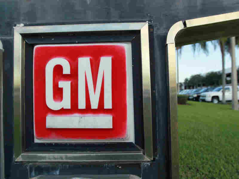 A GM sign near an automobile sales lot. A GM sign near an automobile sales lot.