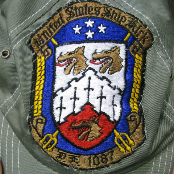Pierre Le shows off the patch that a crew member of the USS Kirk gave him 35 years ago.