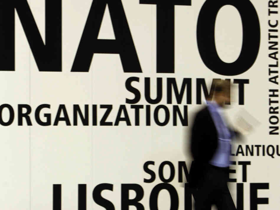 A man walks by NATO's summit venue in Lisbon. A man walks by NATO's summit venue in Lisbon.