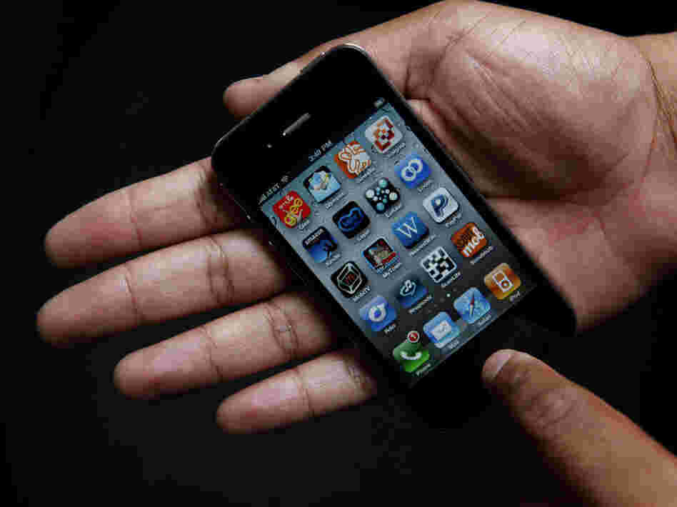 An iPhone in the palm of a hand. An iPhone in the palm of a hand.